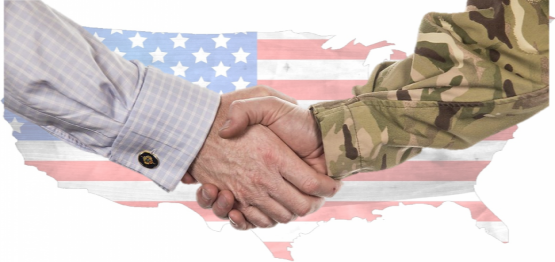 veteran and civilian handshake over a background of US flag